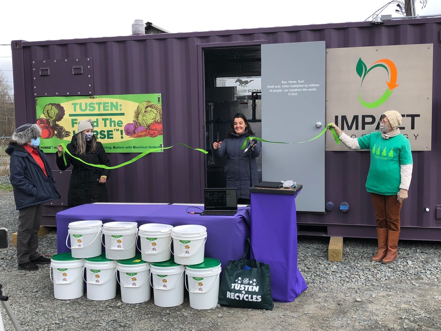 Catherine Lewis and Brandi Merolla, left, and Star Hesse, right, watch as Jennifer Porter cuts the ribbon on April 22, 2021 of the Tusten HORSE. The plan at the time indicated that food waste would be collected in five-gallon food-grade buckets, donated by Weiss Markets’ Bakery Department, from seven different food establishments to start: 2 Queens, Pete’s Market, The Heron, The Laundrette, Blue Fox Motel, Forestburgh Playhouse via Jill Padua, and the Botanist. The digester at full capacity can handle 4000 lbs of food a month, which is 66 buckets a week.